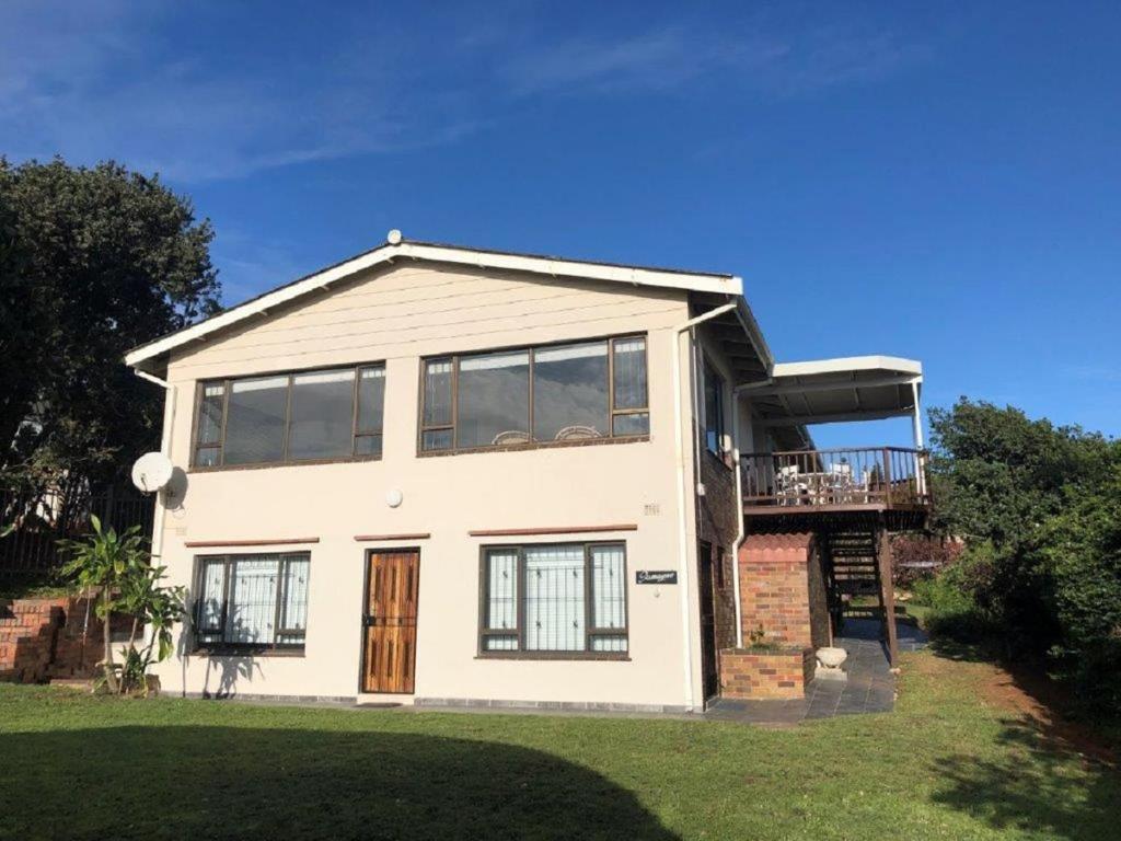 a large white house with a deck on top at 26 Marion Road in Ballito
