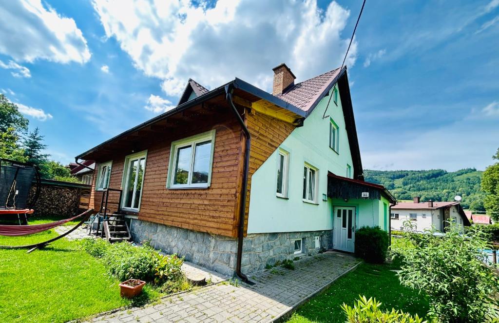 a small house with a wooden roof at Apartmama Lipová in Lipova Lazne