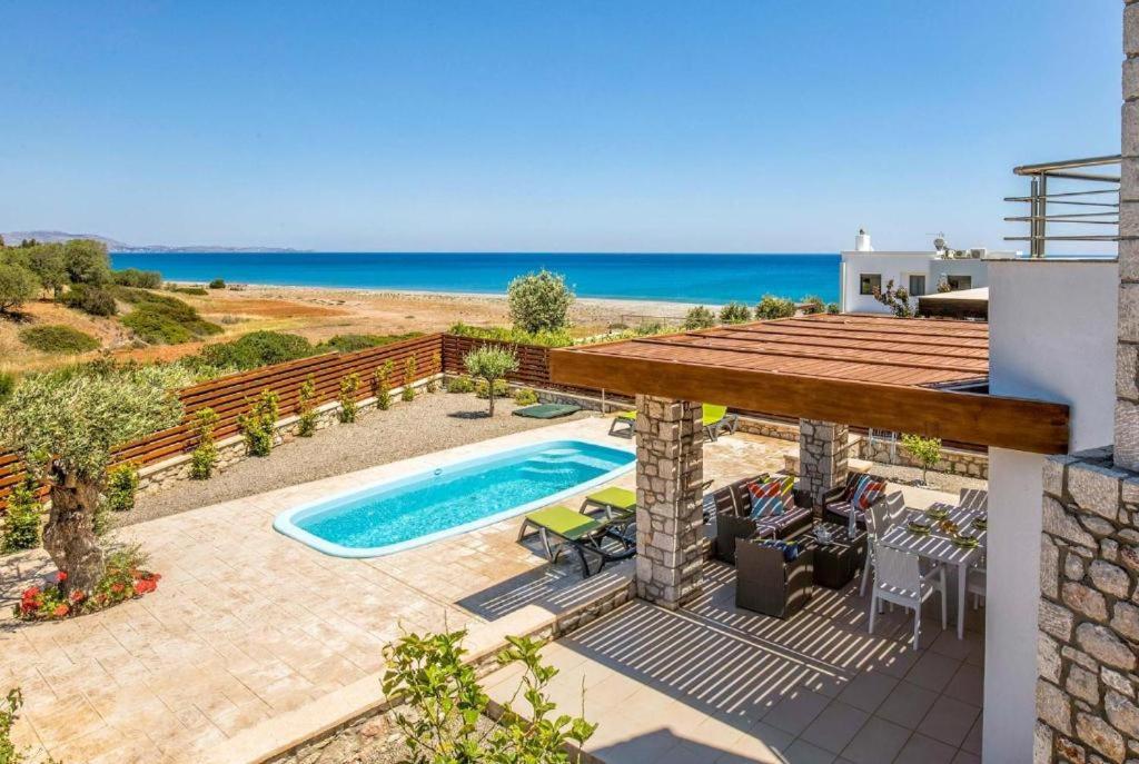 a villa with a swimming pool and the beach at Villa Ira in Lachania