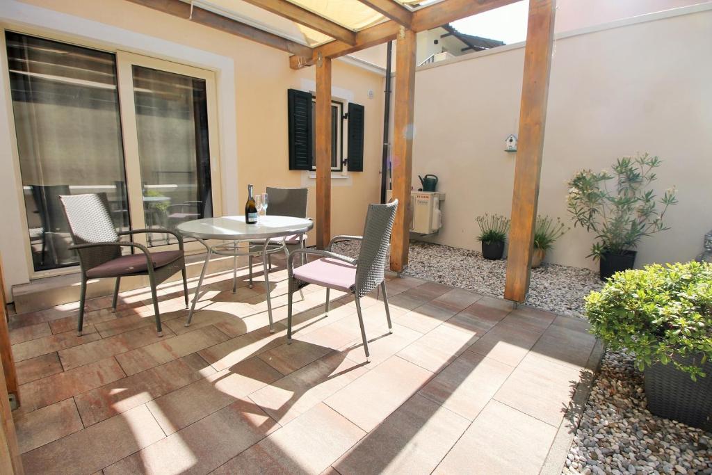 a patio with a table and chairs on it at Irina in Poreč