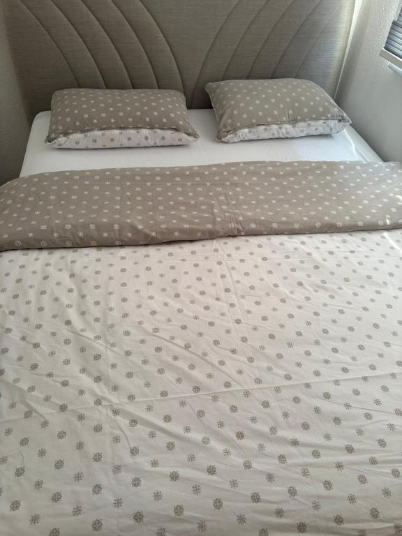 a bed with two pillows on top of it at Apartment Victoria in Foča