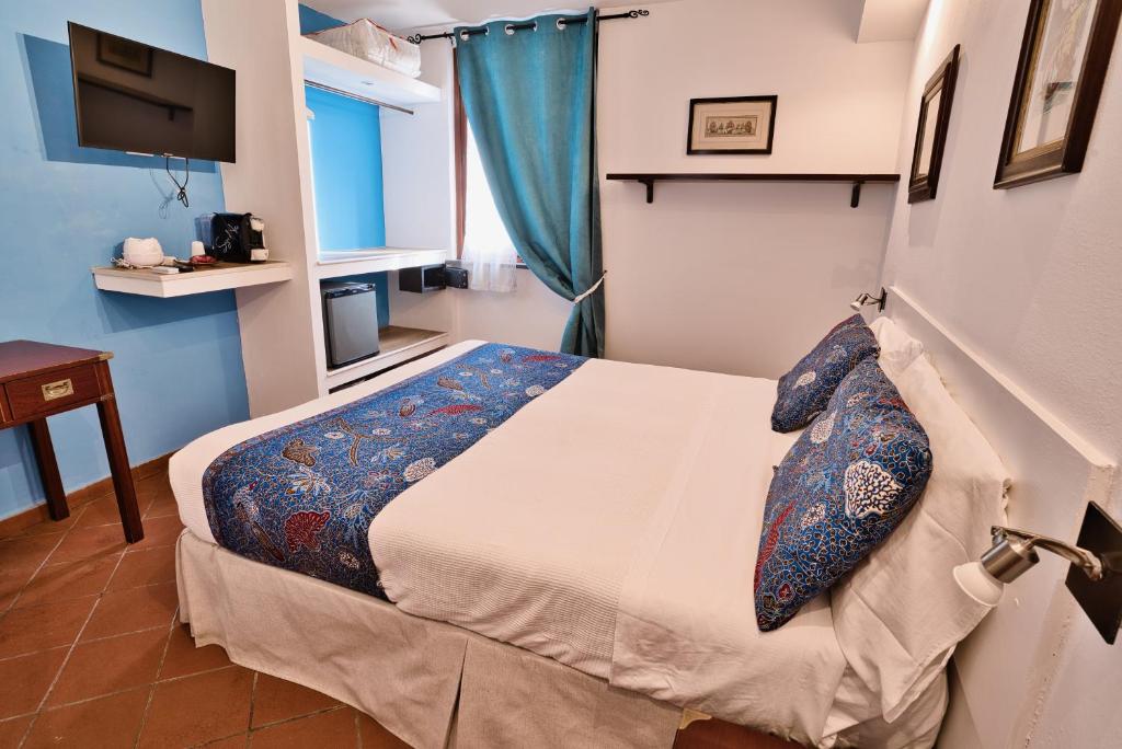 Postel nebo postele na pokoji v ubytování Il Saracino boutique suites