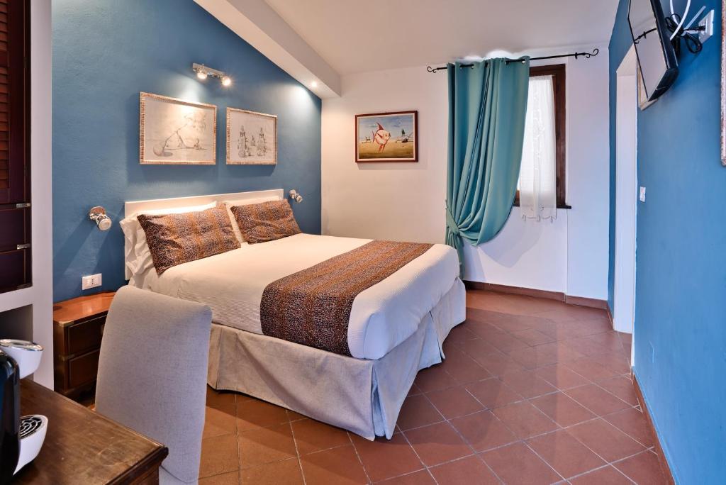 Postel nebo postele na pokoji v ubytování Il Saracino boutique suites