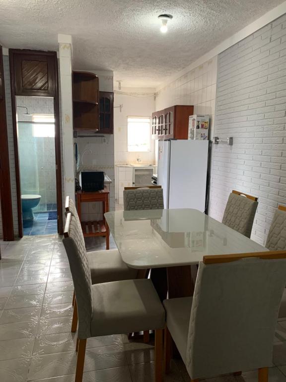 a kitchen with a white table and chairs and a refrigerator at COP 30 - apt Residencial Cesário Alvim in Belém