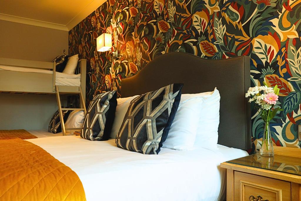 a bedroom with a bed and a floral wall at The Newgrange Hotel in Navan