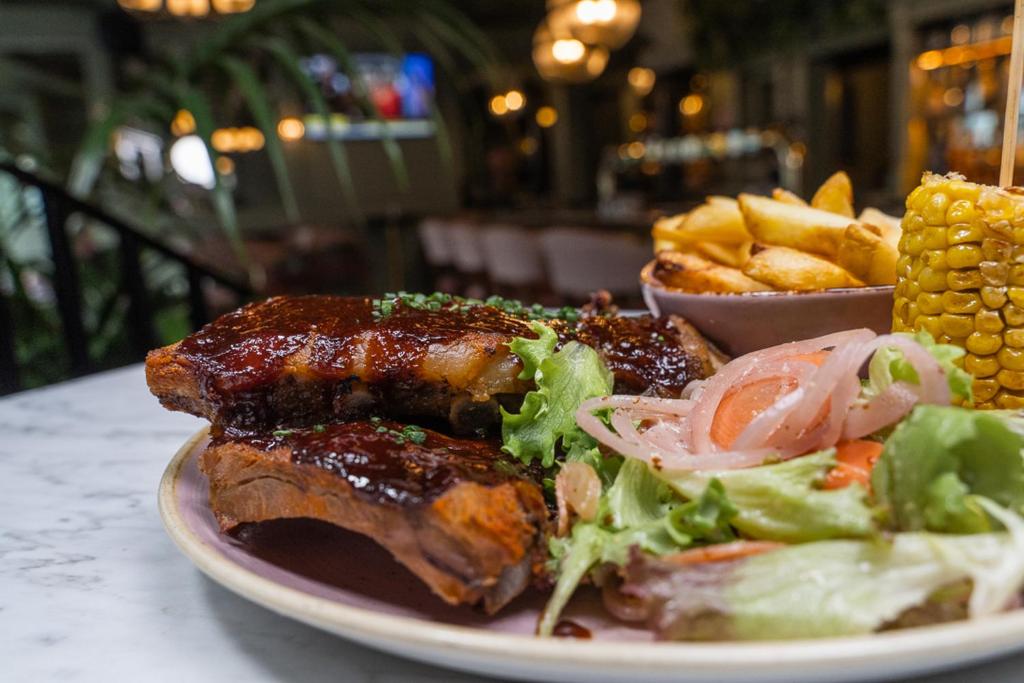 a plate of food with meat and salad and french fries at The Newgrange Hotel in Navan
