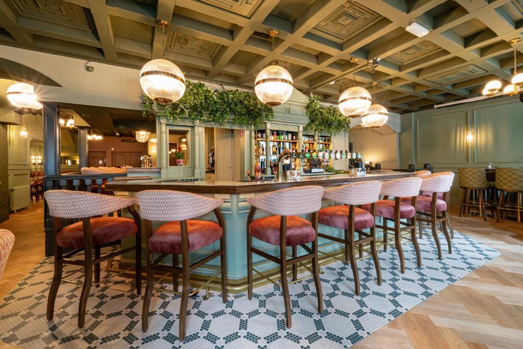 a bar in a restaurant with stools at a counter at The Newgrange Hotel in Navan