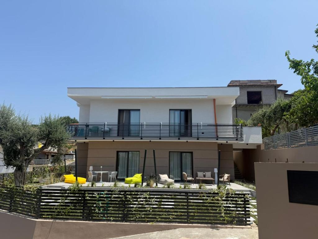 a house with chairs and tables in front of it at Dimoradipa in Santa Maria di Castellabate