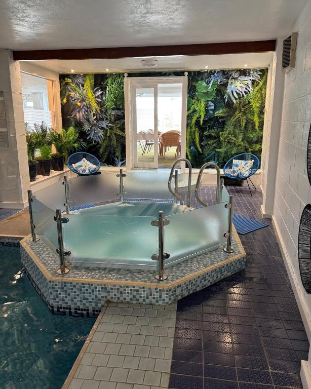 a bath tub in a house with a swimming pool at Park Manor Hotel in Scarborough