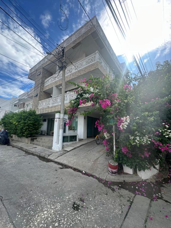 a building with pink flowers in front of it at Casona La Española in Cartagena de Indias