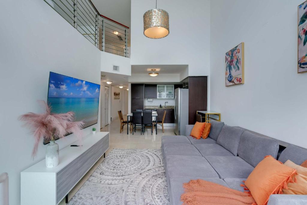 a living room with a couch and a dining room at Brickell River Views- modern amenities in the city in Miami
