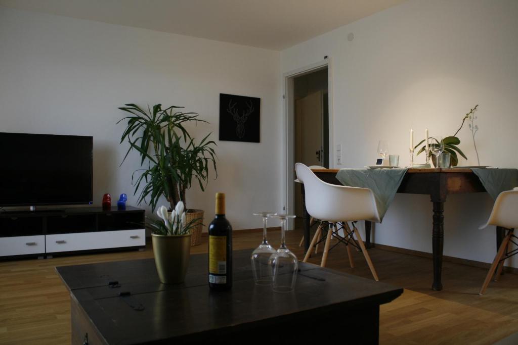 a living room with a table and a piano at Ferienwohnung Weitblick in Freiamt