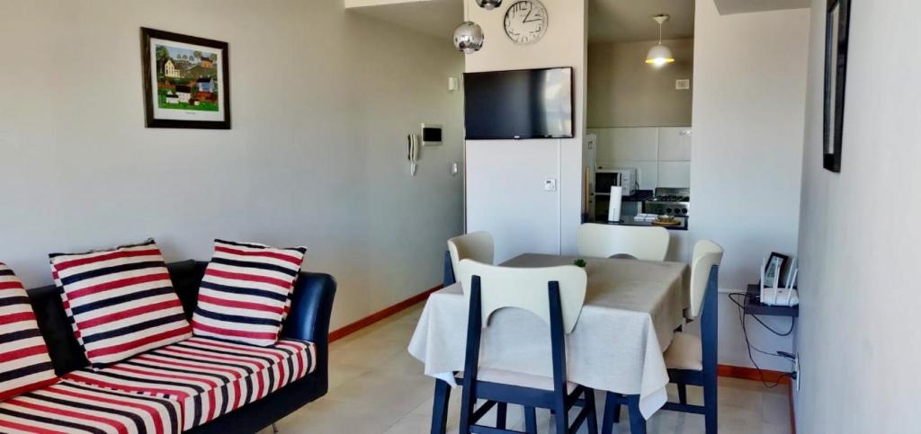 a living room with a dining room table and chairs at Departamento Céntrico in Puerto Madryn