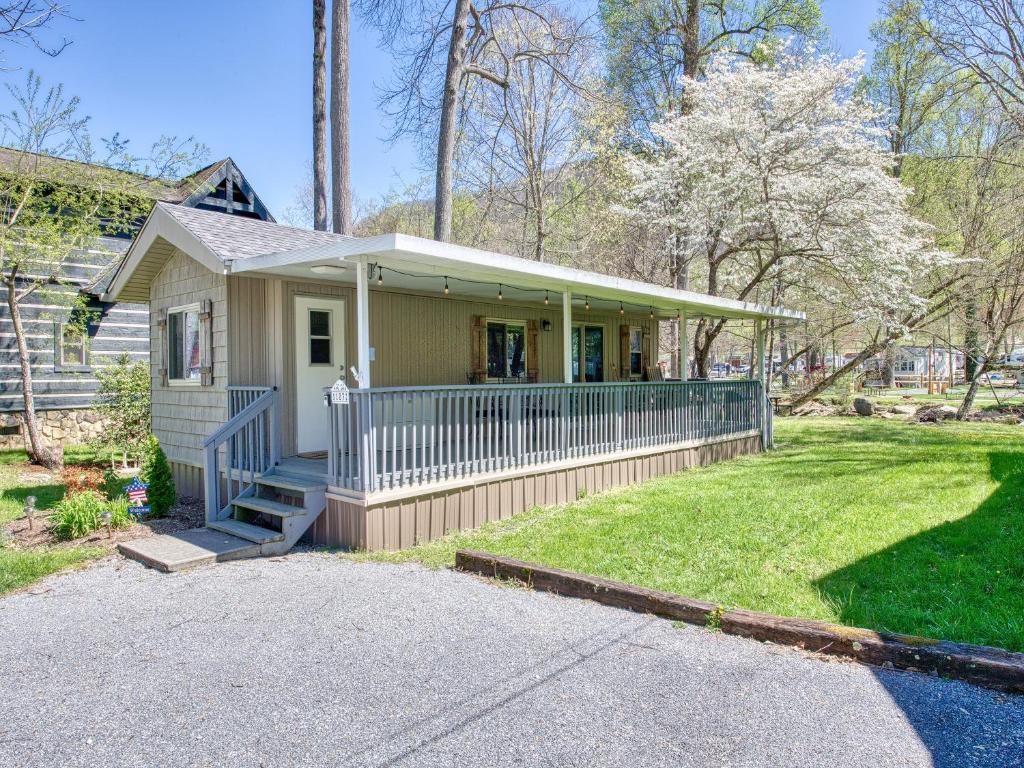 a small house with a porch and a lawn at Perfect for Your Mountain Getaway in Maggie Valley