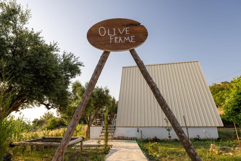 a sign that says olive frame in front of a building at Olive Frame in Zakynthos