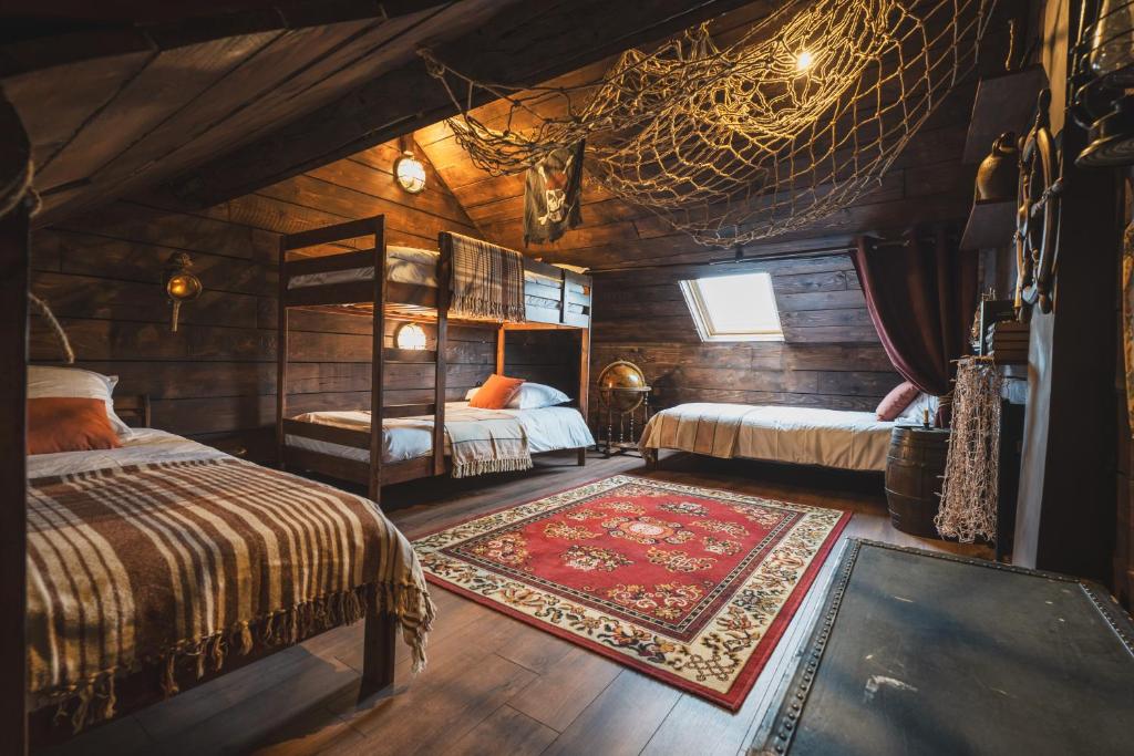 a bedroom with two beds and a rug at 1 maison 5 décors de films cultes Minerva Studio 