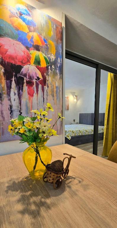 a vase with flowers on a table with a painting at Old-Timer 2 Central Varna in Varna City