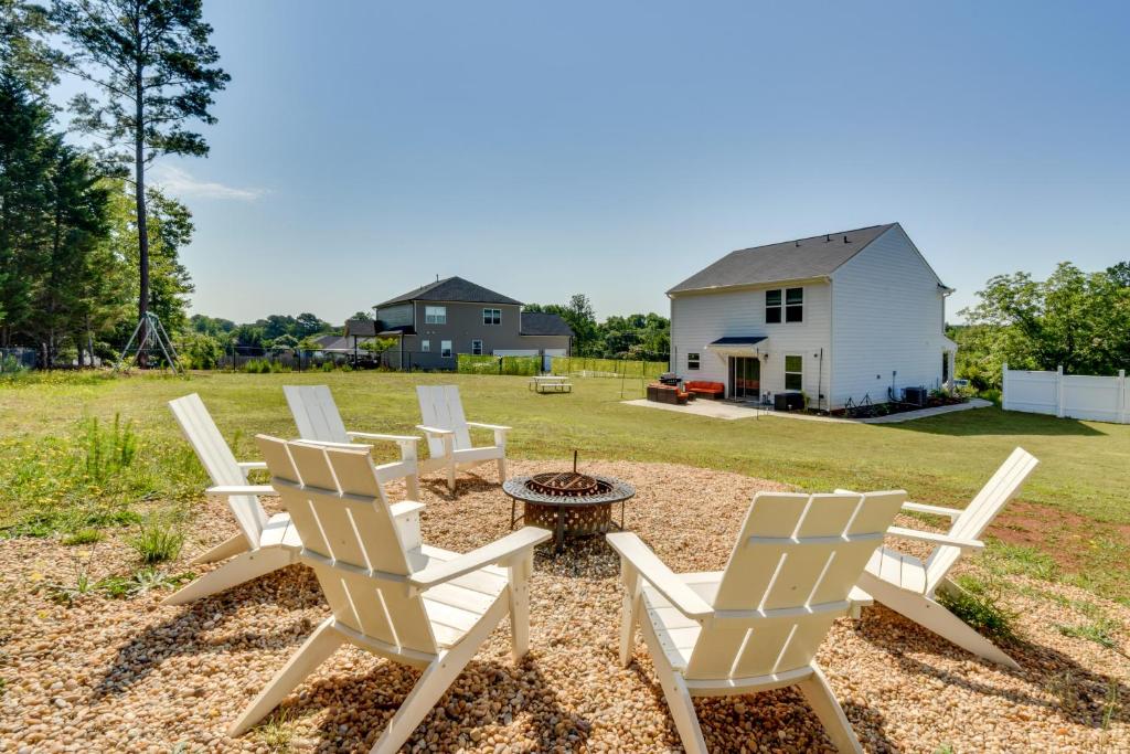 a group of white chairs and a table in a yard at Less Than 1 Mi to Lake Hartwell! Home with Pet-Friendly Yard in Anderson