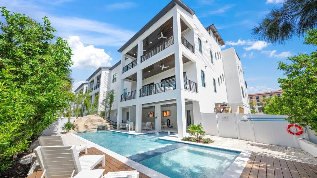 an exterior view of a house with a swimming pool at Salty Sunrise in Clearwater Beach