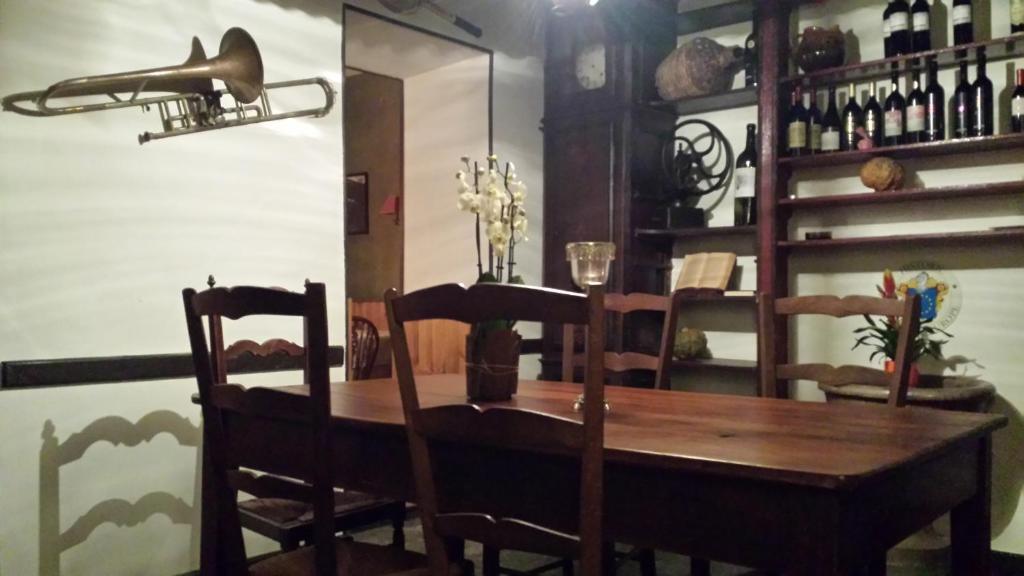 a dining room with a wooden table and chairs at Albergo della Posta in Astano