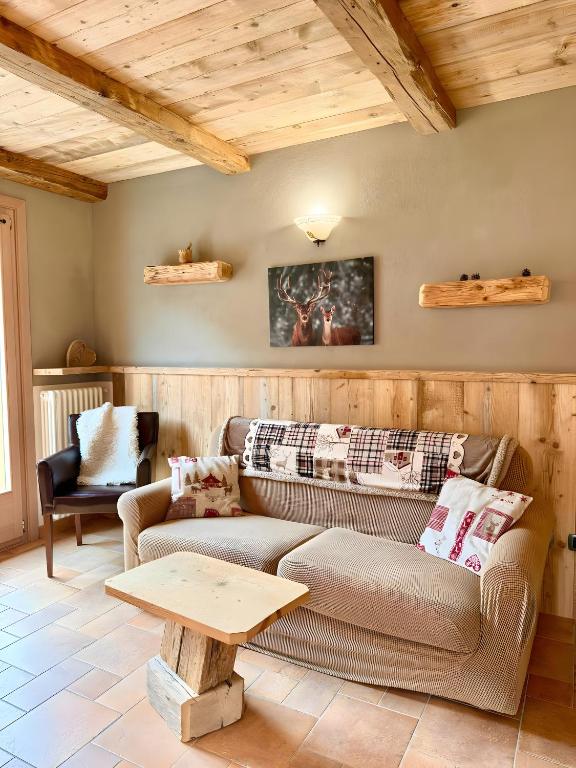 a living room with a couch and a table at Casa Clus Bormio apartments 3 in Valdisotto