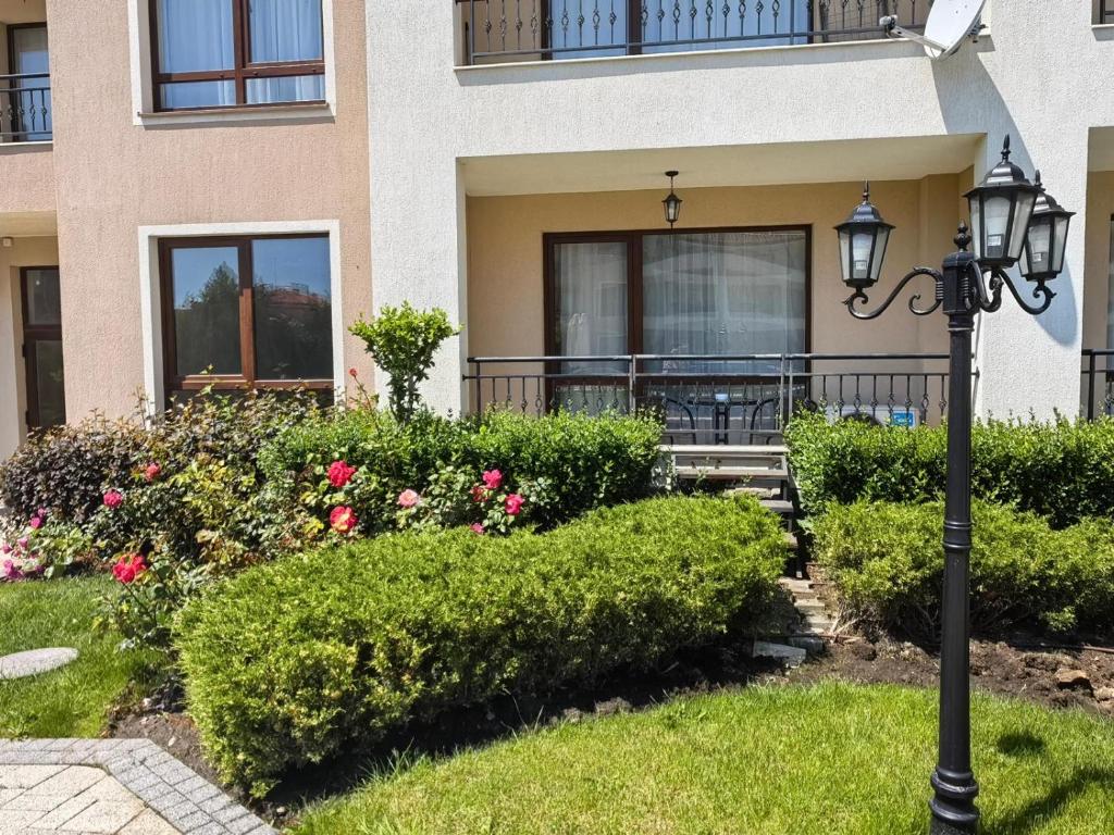 a street light in front of a house with flowers at Sea Dreams Studio in Sveti Vlas