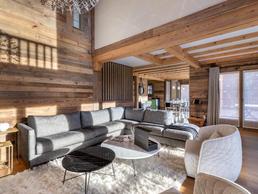 a living room with a couch and a table at Chalet avec jacuzzi, proche des pistes, pour 10 personnes - FR-1-570-20 in Saint-Martin-de-Belleville
