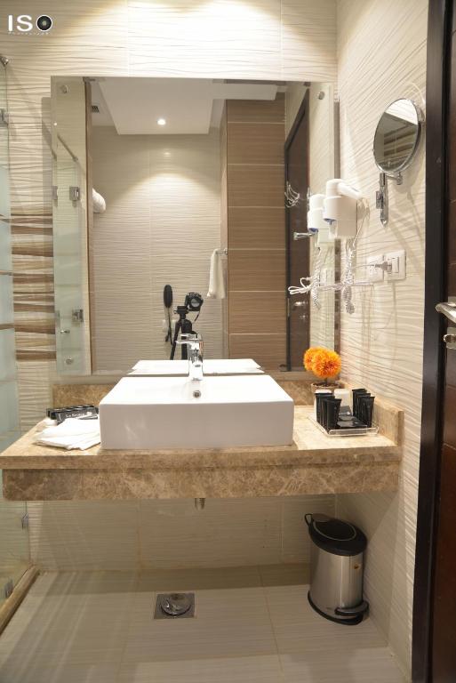 a bathroom with a white sink and a mirror at Tolip El Narges in Cairo