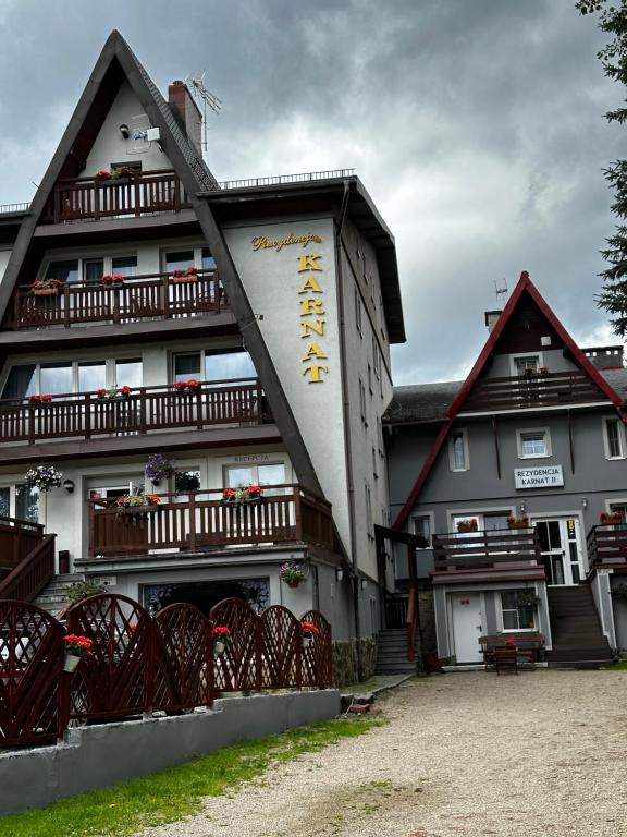 a large white building with a sign on it at Rezydencja Karnat in Karpacz