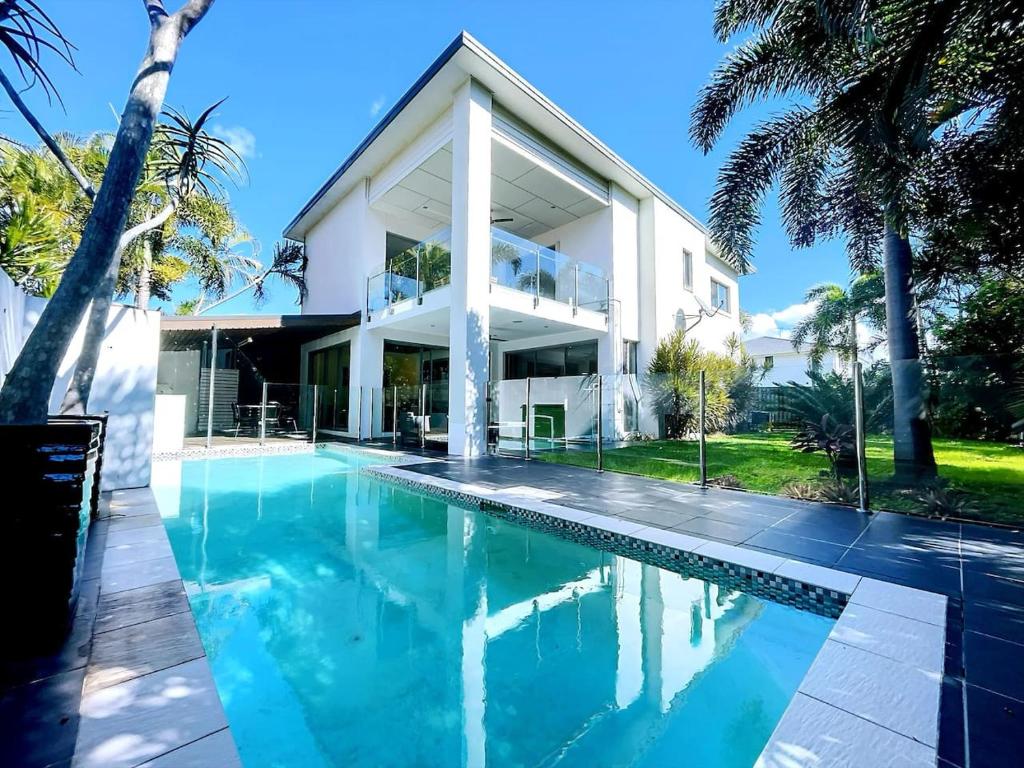 a house with a swimming pool in front of it at 4 Ensuites Patio Pool BBQ Billiards Media Room in Algester