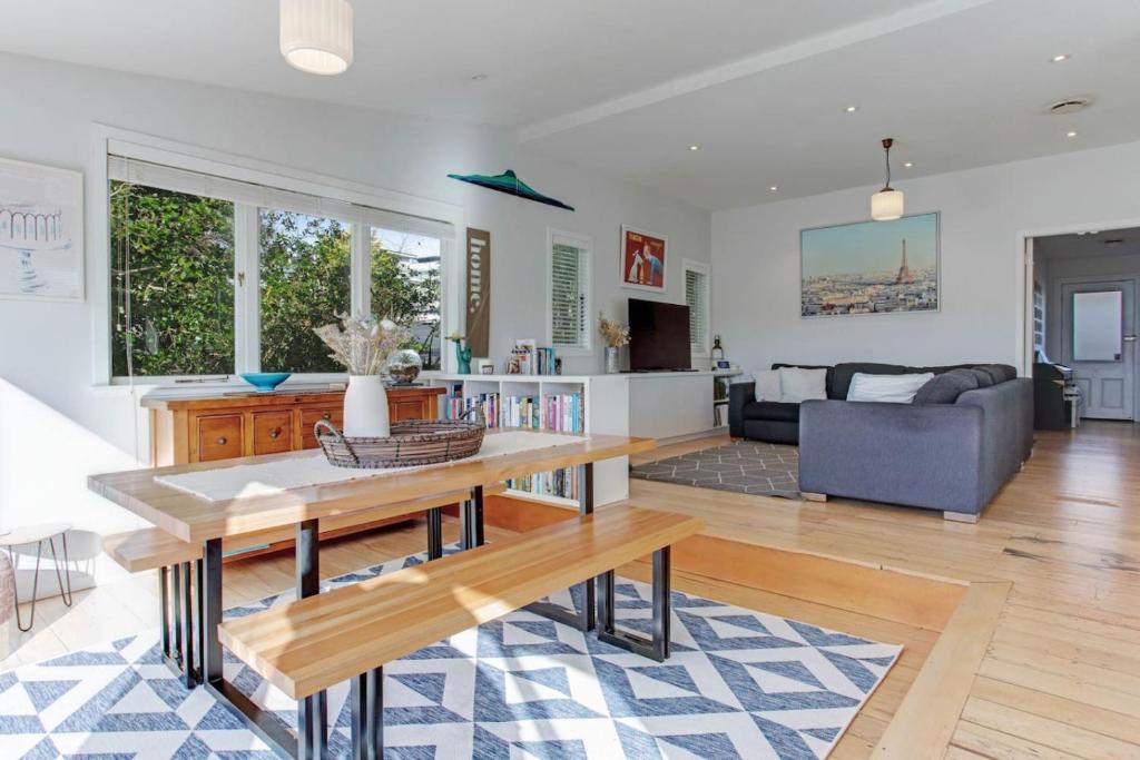 a living room with a table and a couch at Perfect Family Home in Central Auckland in Auckland