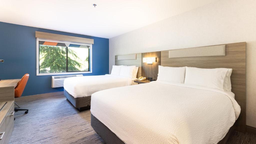 a hotel room with two beds and a window at Holiday Inn Express Bellingham by IHG in Bellingham