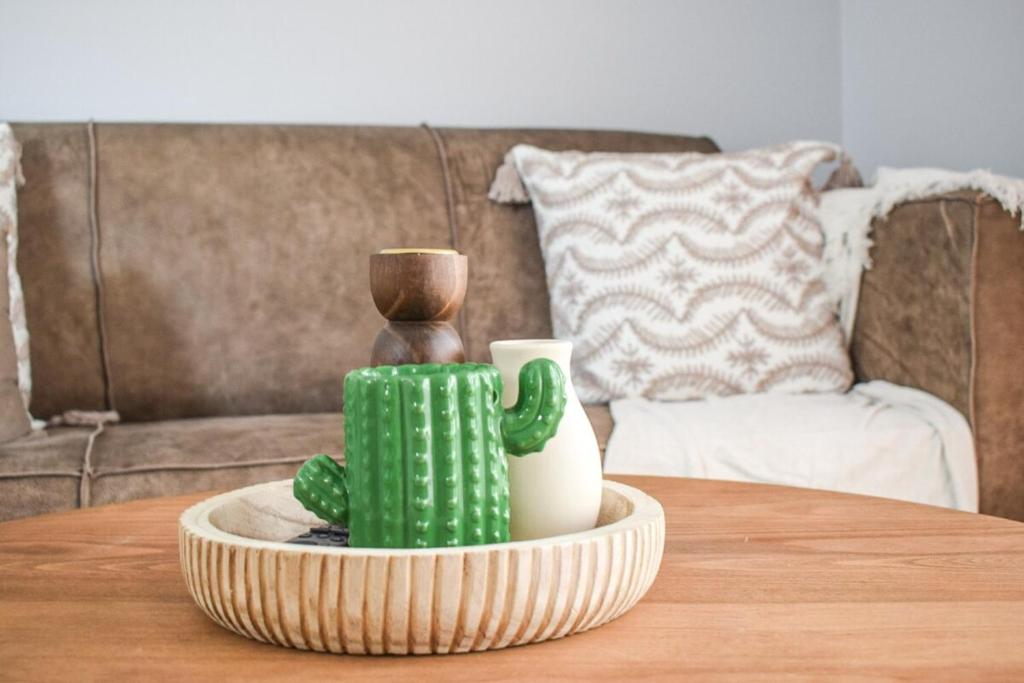 a table with a cactus and two vases on it at Desert Nest II in Swakopmund
