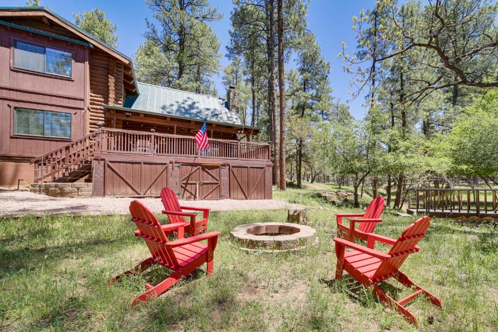 a group of red chairs in front of a log cabin at Covered Deck, Private Acreage: Log Cabin in Pine in Pine