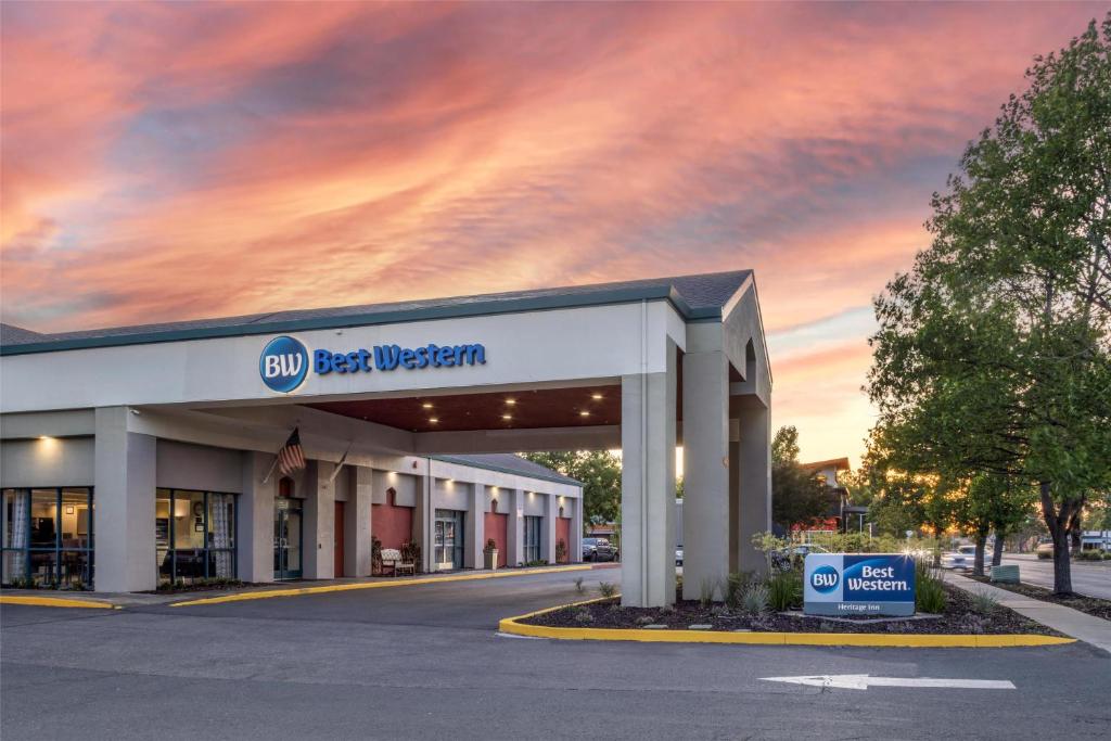 a best western building with a cloudy sky at Best Western Heritage Inn in Concord