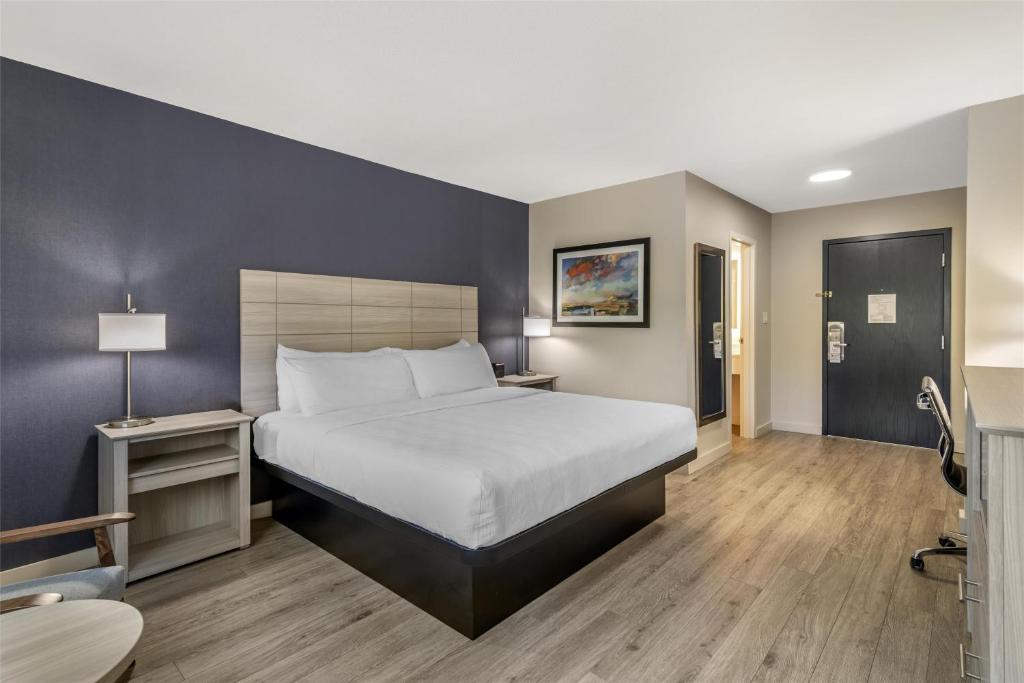 a hotel room with a bed and a desk and a chair at Best Western Caribou Inn in Caribou