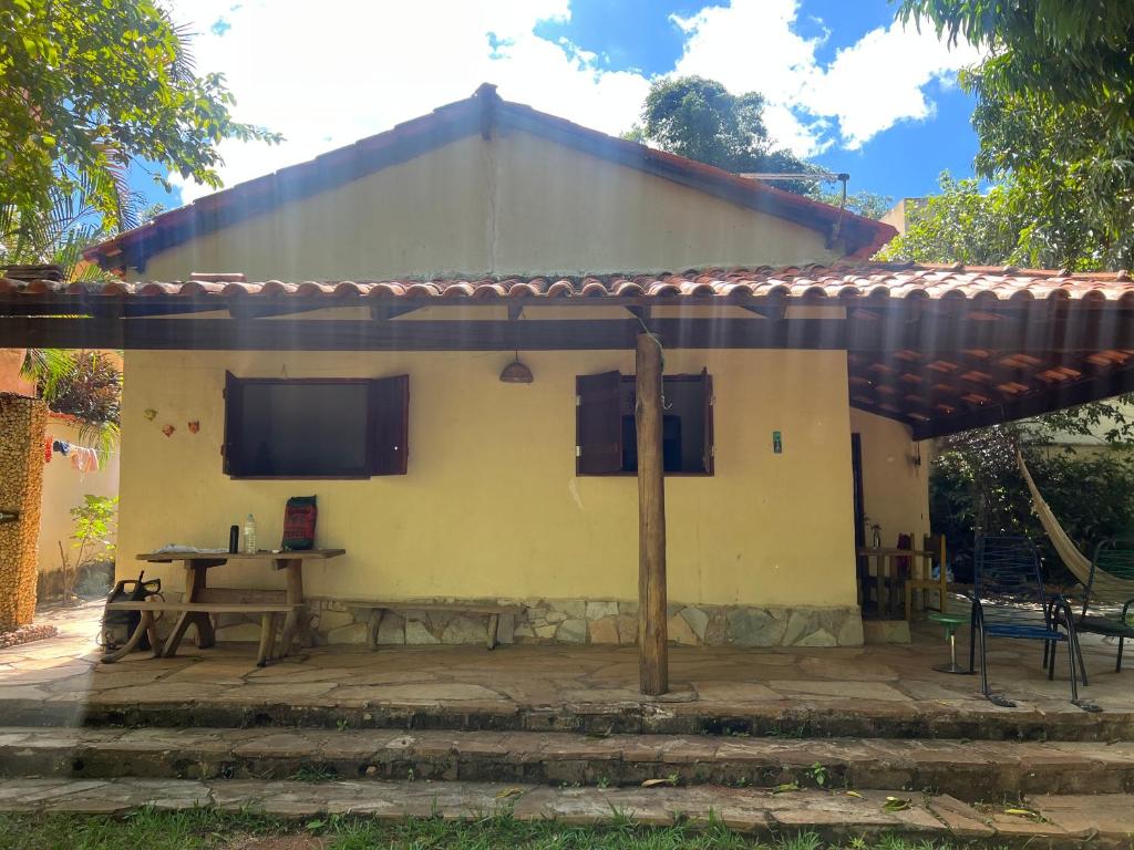 a house with a table in front of it at Cerrado house in Pirenópolis