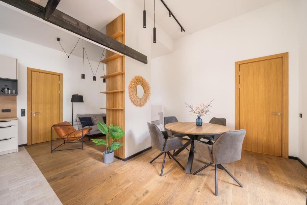 a kitchen and dining room with a table and chairs at Edinburgh loft-style apartments in Jūrmala