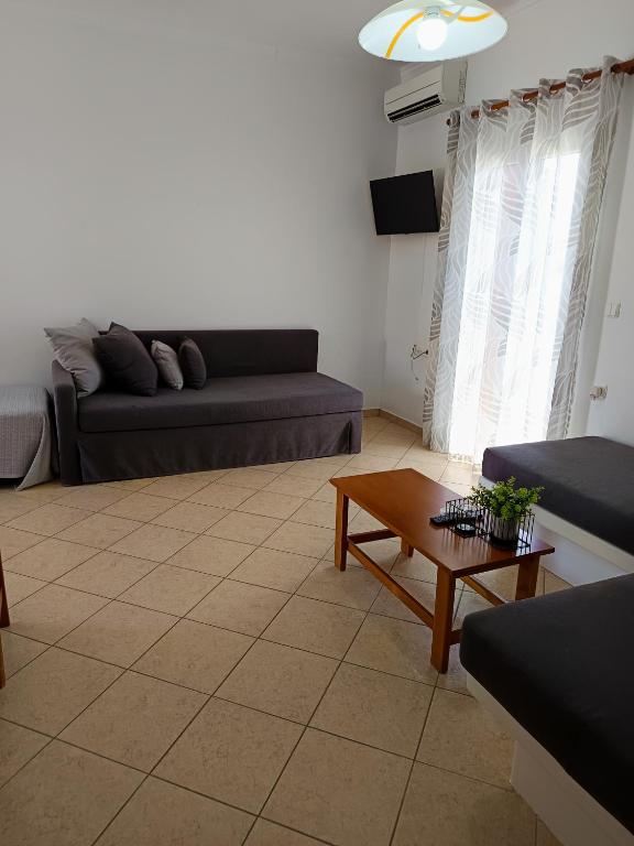 a living room with a couch and a coffee table at Vythos in Adamas