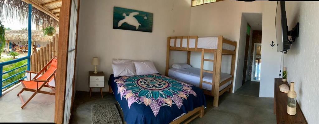 a bedroom with a bed and a bunk bed at Casa Montemar in Caleta Grau