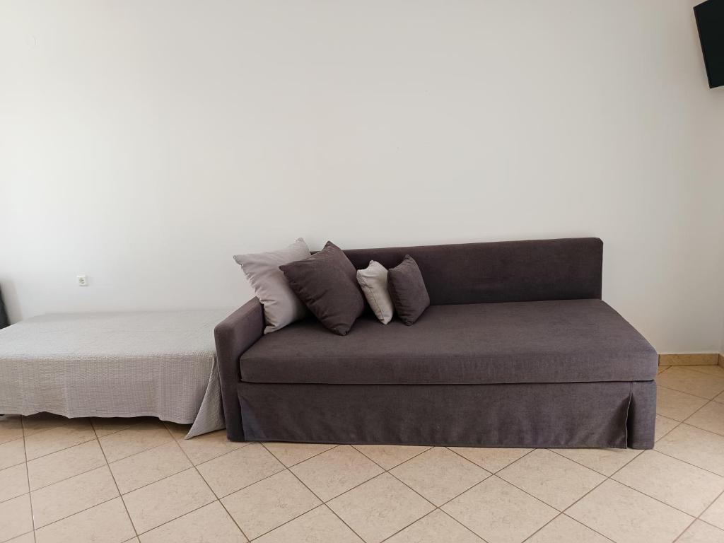 a couch with pillows on it in a room at Vythos in Adamas
