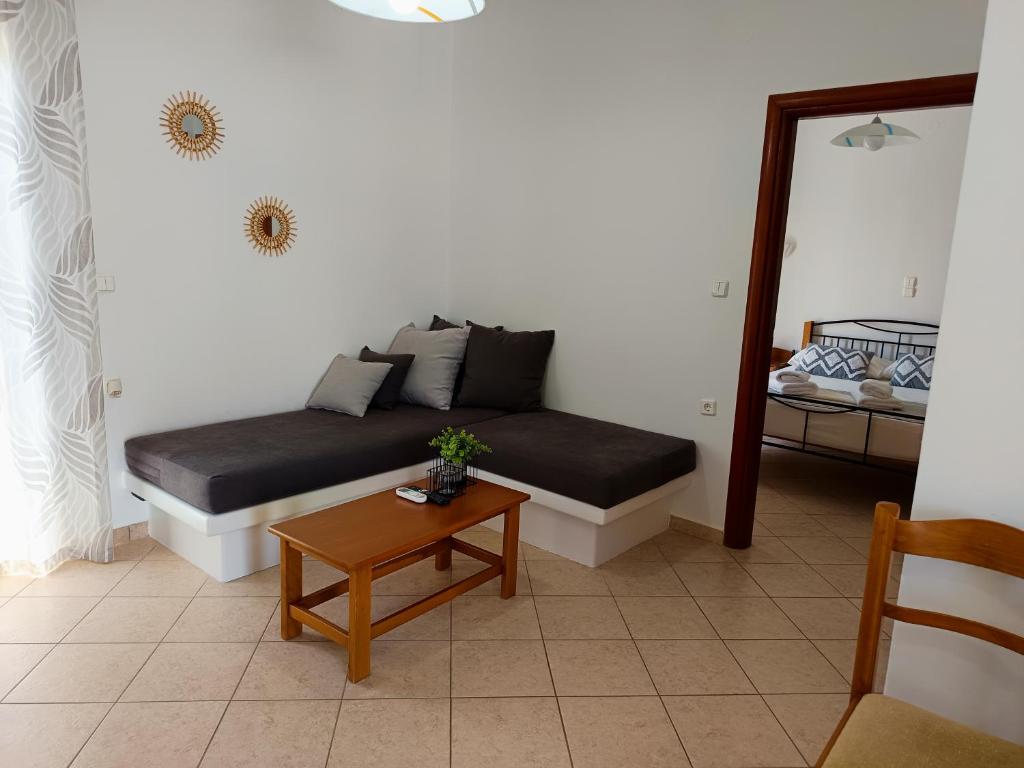 a bed in a room with a table and a mirror at Vythos in Adamas