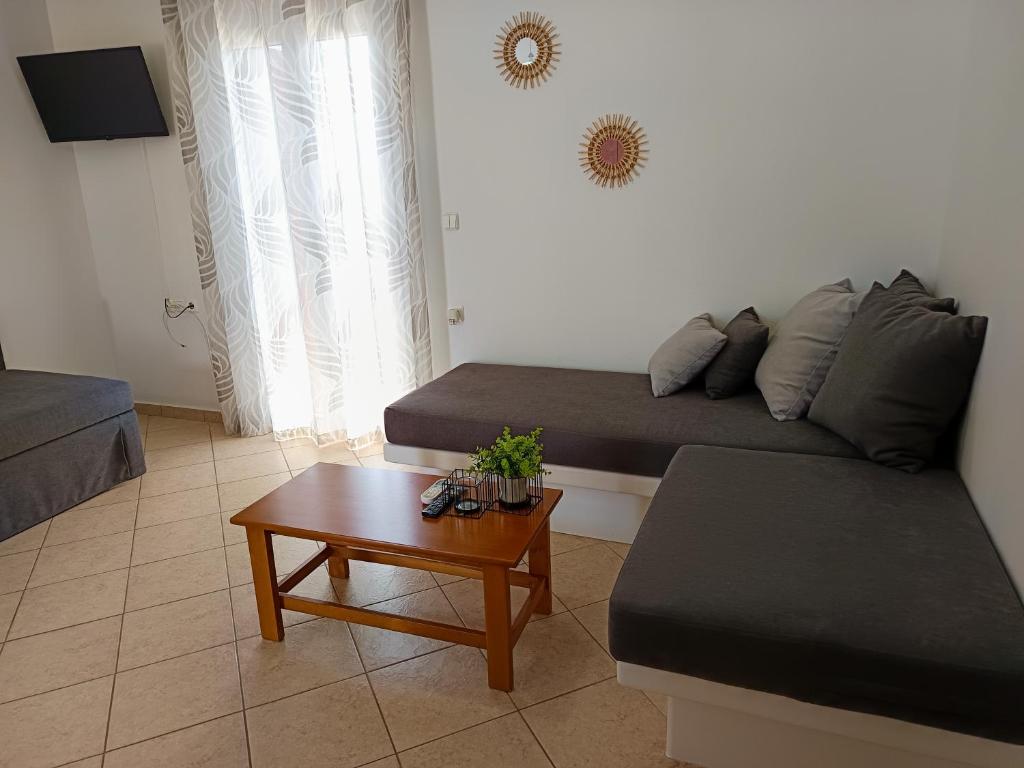 a living room with a couch and a coffee table at Vythos in Adamas