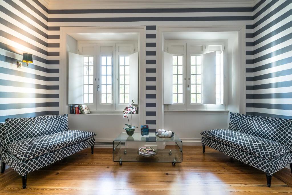 a living room with two couches and a table at Villa Vasco da Gama in Cascais