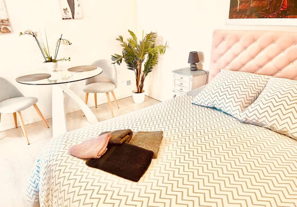 a bedroom with a bed with a purse and a table at Maison du bonheur in Cagnes-sur-Mer