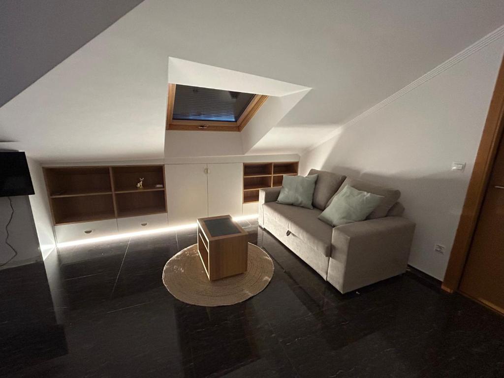 a living room with a couch and a table at Vista Santa Mariña in Cambados