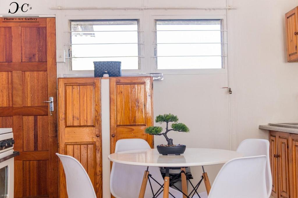 a kitchen with a white table and white chairs at ZM Rooted Properties in Frankfort