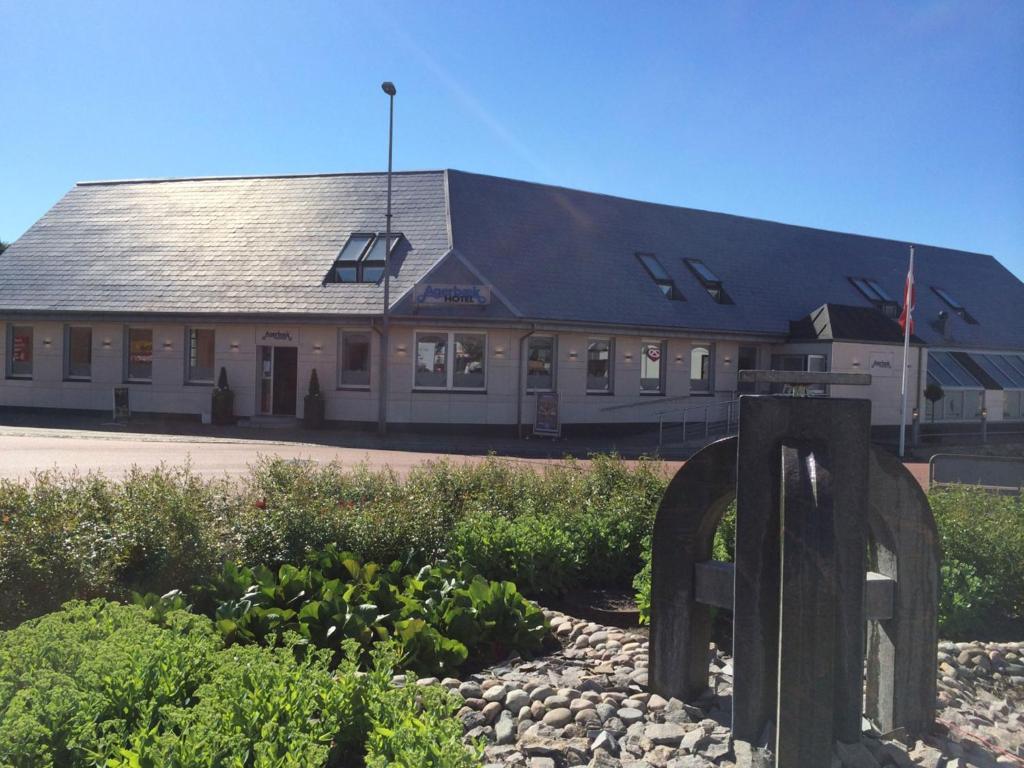 a building with a sign in front of it at Agerbæk Hotel in Agerbæk