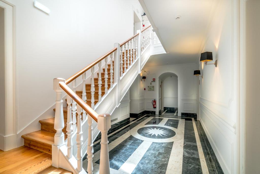 a hallway with stairs and a tile floor at Villa Vasco da Gama in Cascais