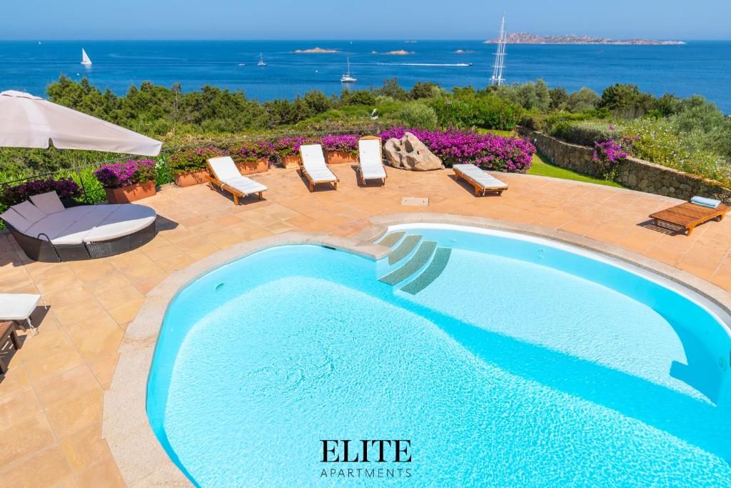 a swimming pool in a patio with a view of the ocean at Villa Romazzino con vista mare in Abbiadori
